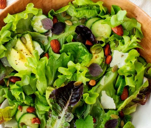 Refreshing green salad: a vibrant and healthy mix of crisp greens, colorful vegetables, and tangy dressing.