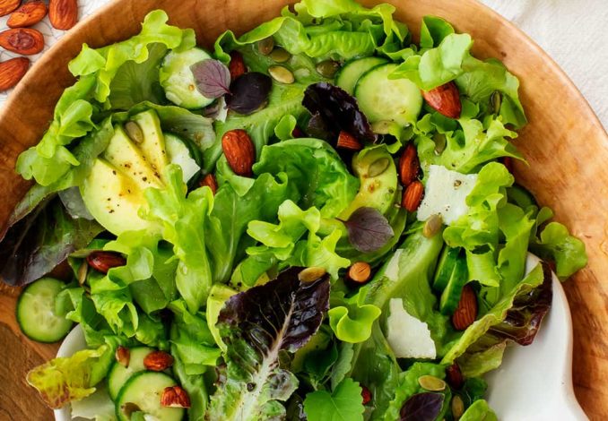 Refreshing green salad: a vibrant and healthy mix of crisp greens, colorful vegetables, and tangy dressing.