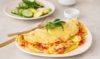 Colorful omelette bursting with vibrant vegetables and flavorful herbs.
