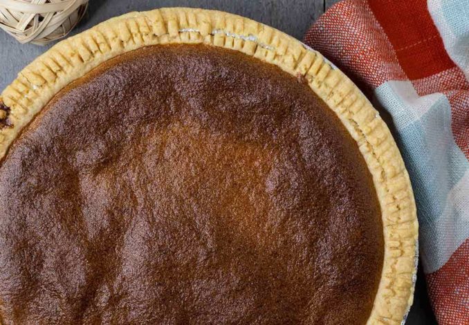 Scrumptious brown pie with a golden crust, filled with a rich and flavorful combination of ingredients.